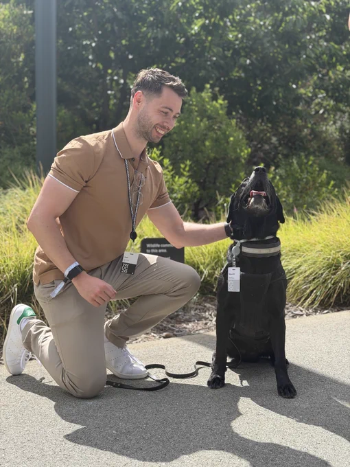 Photo of Aled with Beau while Aled is petting him.