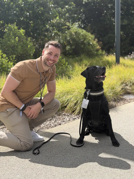 Photo of Aled with Beau while Beau is looking at a tennis ball out of picture.
