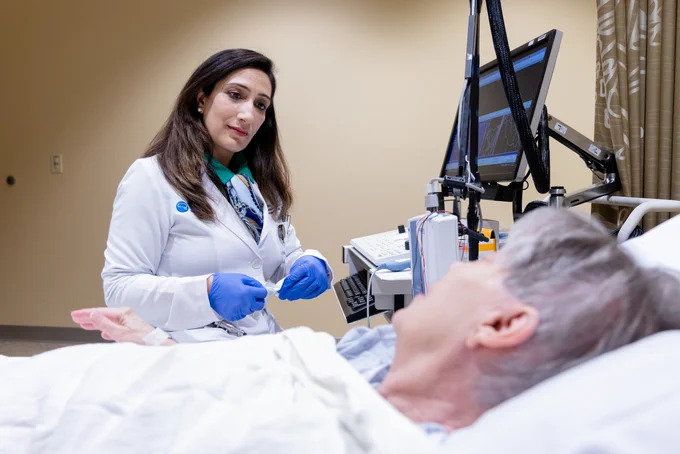 Dr. Chugh tends to a patient in clinic