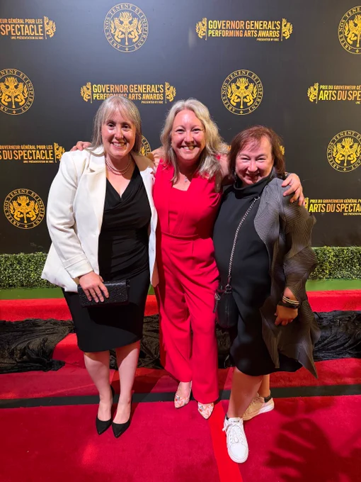 Three women smiling and posting together for a photograph at the Governor General's Performing Arts Awards.
