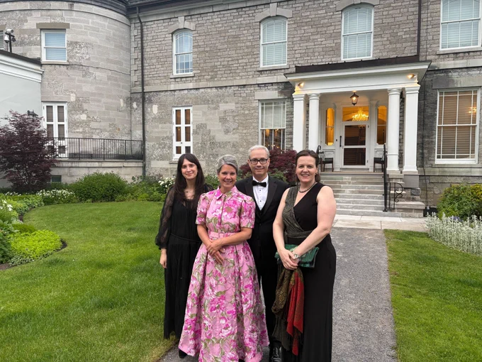 Three women and one man in formal attire pose for a photo outside Rideau Hall while attending the Governor General's Performing Arts Awards ceremony. 