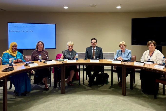 Image of the panelists, seated in a circular configuration