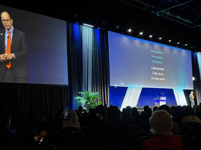 Dr. Eric Small delivers the opening talk for ASCO 2026. The slide behind him reads, in English and Spanish: Every patient. Every cancer. Everywhere.