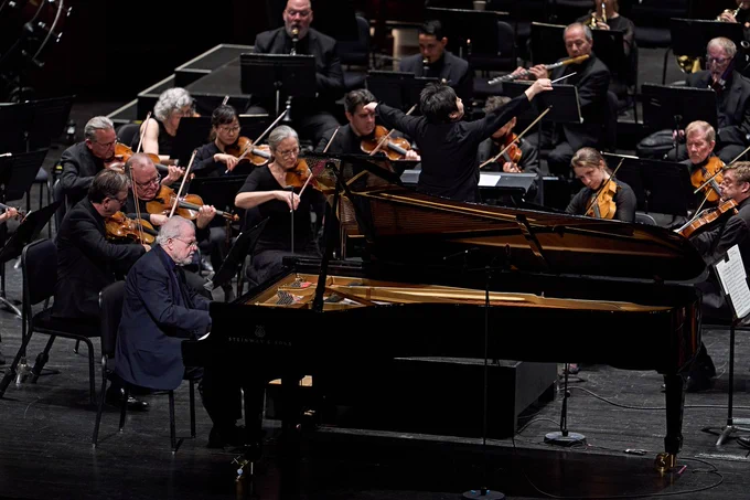 Music Director Xian Zhang conducts New Jersey Symphony musicians while Emanuel Ax plays the piano.