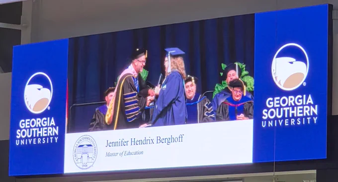 Jennifer walking across the stage to receive her master’s degree from Georgia Southern University.