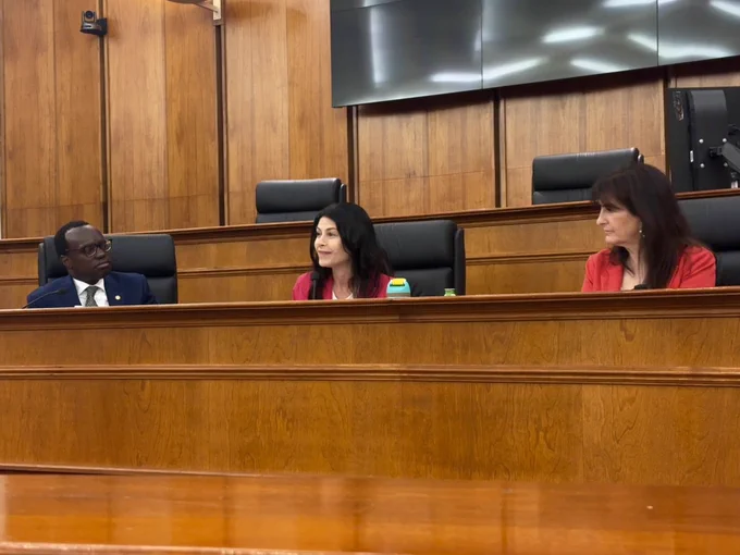 Deputy SOS Edevbie and Oakland Co Clerk Brown listen as AG Nessel speaks