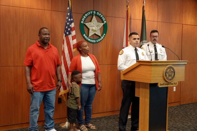 MDFR Lt. Jesus Fuentes, BSO Fire Rescue FF Broderick Espinoza with Tyler Nelson and family.