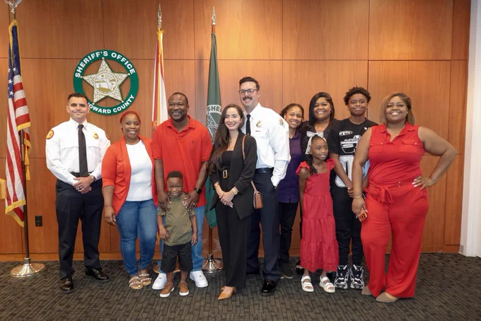 MDFR Lt. Jesus Fuentes, BSO Fire Rescue FF Broderick Espinoza with Tyler Nelson and family.