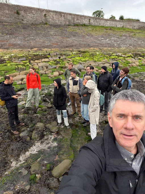 Group photo of the Deep Time Cognition team at the shore of Wardie Bay at low tide to collect 335-million-year-old fossils (lots of fish and plants are known but we mostly found shark spiral coprolites). Here Steve Brusatte is giving us a run-down of the history and geology of the locality. The fact that the 300th anniversary of the birth of James Hutton, "the Father of Modern Geology," was the day we were there—and Hutton (and Darwin!) collected there—made it extra special!