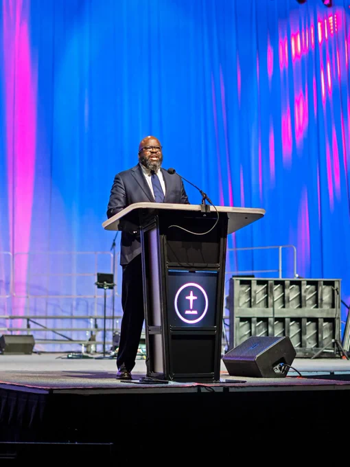 A speaker at a podium on a stage, delivering a speech during the Southern Baptist Convention 2026 at the Orange County Convention Center. 