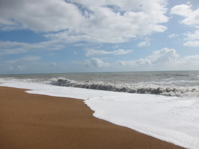 A wave breaks upon a beach.
Photo: frostfire