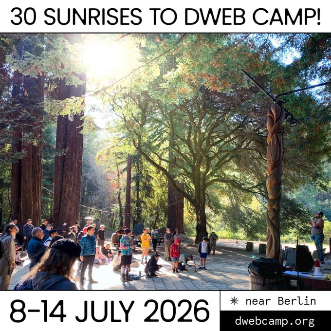 Promotional graphic for DWeb Camp featuring a sun-drenched redwood forest with a crowd of attendees gathered on a stone plaza. Bold text reads "30 Sunrises to DWeb Camp!' A carved wooden totem pole stands to the right. The bottom reads '8–14 July 2026 · near Berlin · dwebcamp.org."