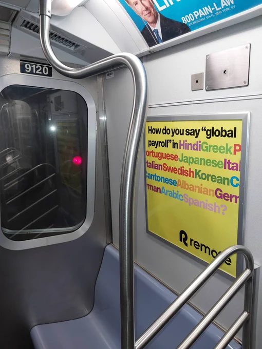 Remote payroll software advertisement inside New York City subway car with yellow background asking "How do you say global payroll in Hindi, Greek, Portuguese, Japanese, Italian, Swedish, Korean, Cantonese, Albanian, German, Arabic, Spanish?"