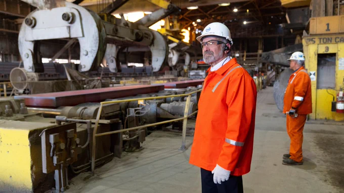Commerce Secretary Lutnick wearing a white hard hat and orange safety jacket touring U. S. Steel Mon Valley Works - Edgar Thomson Plant.