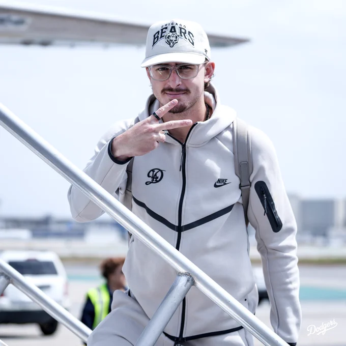 A photo of Justin Wrobleski posing and putting up the peace sign as he boards the plane.