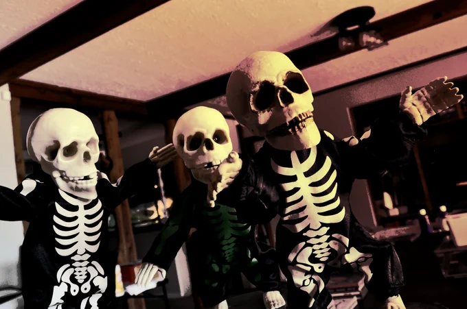 3 dancing skeleton decorations in ominous lighting. Their names, from right to left, are: "Goldilocks," "Gold Island," and "Hey Baby" ✅
