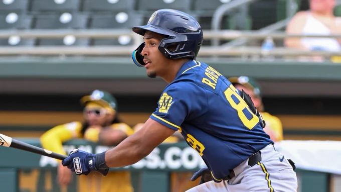 An image of Josiah Ragsdale in a blue Brewers uniform and helmet .