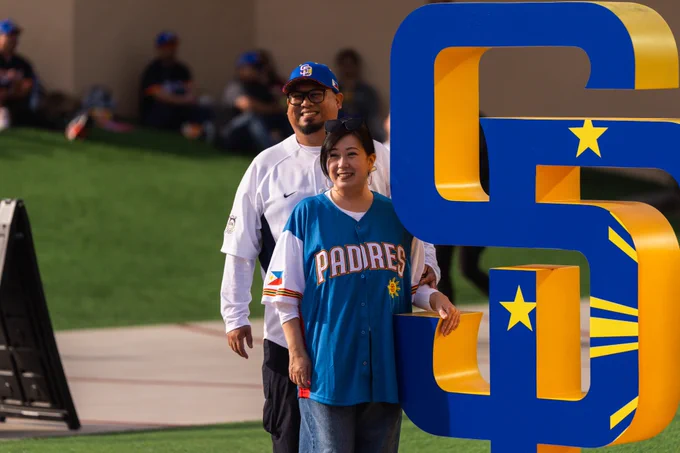Fans smiling next to the SD logo for Filipino Heritage Celebration.