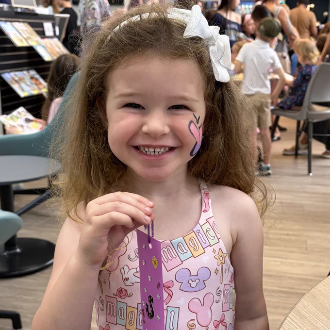 Kid holding a bookmark.