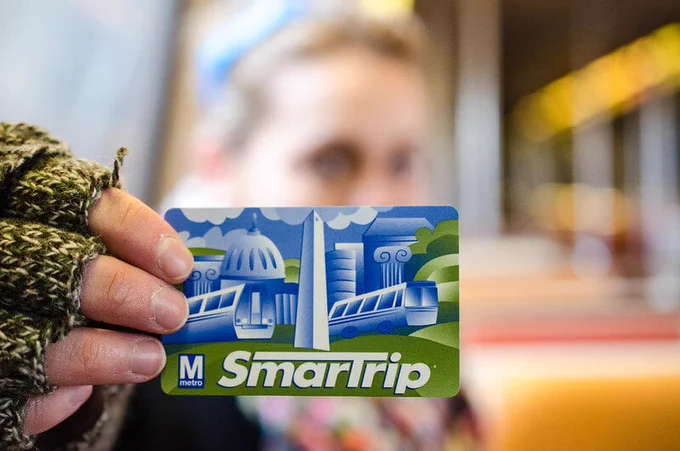 woman holding up smart trip card