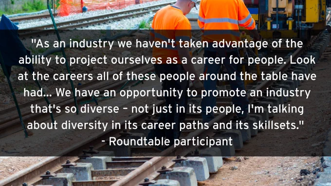 Two workers in orange safety vests inspecting railroad tracks during maintenance work on a sunny day with a quote about rail careers