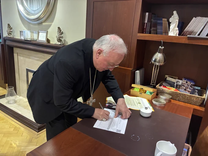 Bishop Philip Egan from the Diocese of Portsmouth signing the CAFOD debt petition. 