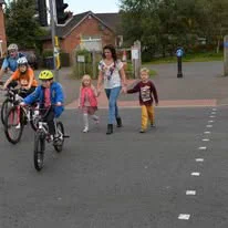 Image of pedestrian, children and cyclists crossing the road.   