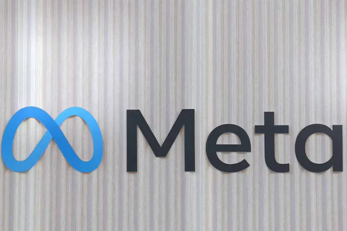 The blue Meta infinity loop logo and text displayed on a vertically striped wall background, representing corporate and tech news.