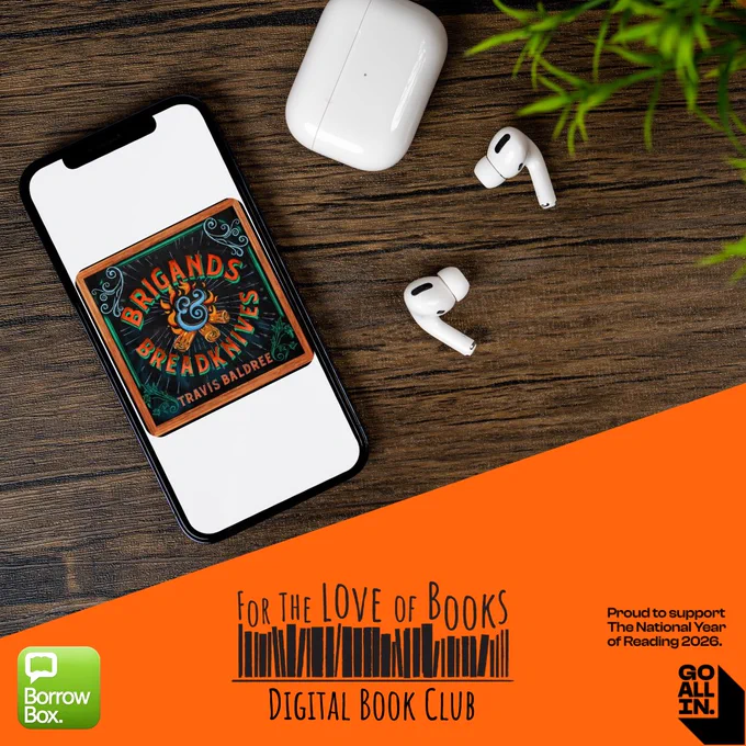 Smartphone displaying the cover of 'Brigands & Breakdknives' by Travis Baldree on a wooden table next to wireless earbuds and their charging case.
