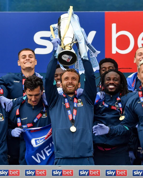 Liam Kelly lifts the League One Trophy.