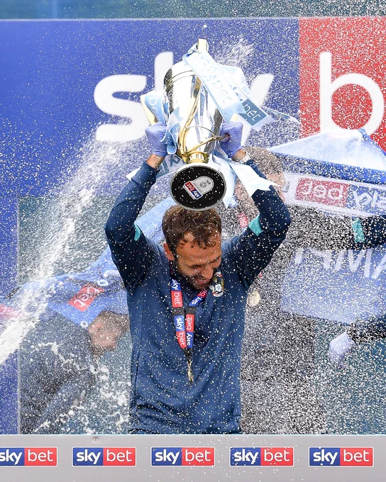 Liam Kelly lifts the League One Trophy.
