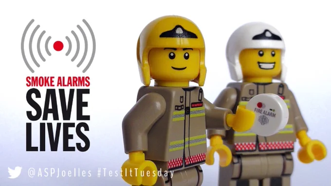 Lego fire fighters with a smoke alarm testing it 