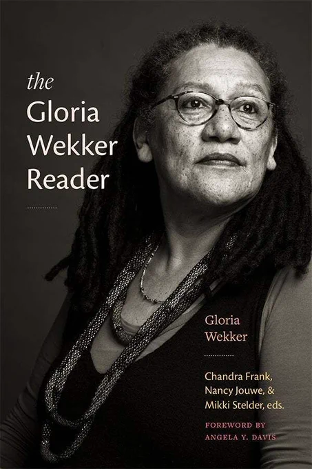 Cover of The Gloria Wekker Reader by Gloria Wekker. The cover has a sepia photograph of Gloria Wekker. The title apears to the left of Wekker's face in a cream sans-serif font. A dotted line is under the title. The author's name is in the bottom right corner in orange with the editors' names in yellow below separated by a cream dotted line. Directly below is written "foreword by Angela Y. Davis" in light red in all caps.
