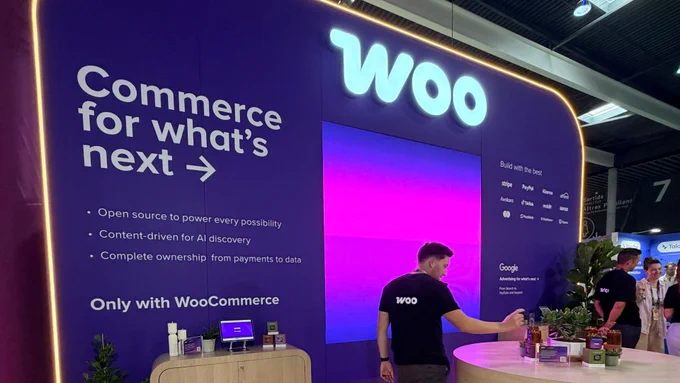 A person stands at the Woo booth at Shoptalk Europe in front of a wall that says, “Woo: Commerce for what's next.”