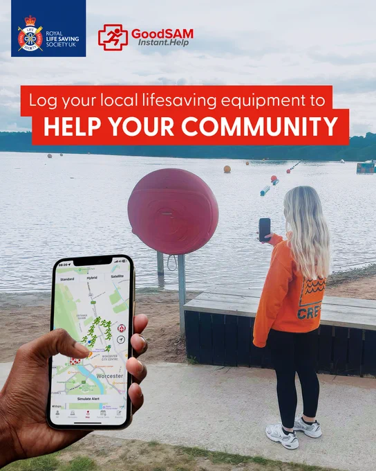 Person standing by a lake, holding up a smartphone to take a picture of lifesaving equipment. A large red ring buoy is visible in the background. Another hand in the foreground holds a phone displaying a map with locations. Text reads, "Log your local lifesaving equipment to help your community." Logos of Royal Life Saving Society UK and GoodSAM Instant.Help are present.