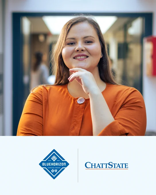 Young woman in an orange shirt with a thoughtful pose standing indoors near a glass door with blurred background. BCBS BlueHorizon and ChattState logos.