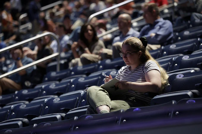 A female student attends devotional at the Marriott Center