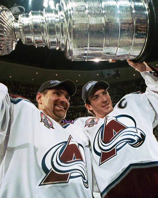 The iconic photo of Ray Bourque and Joe Sakic hoisting the Stanley Cup over their heads. 