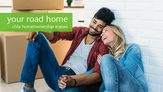 A couple sitting together on the floor of their new home with the text “Your road home, CHFA homeownership enews”.