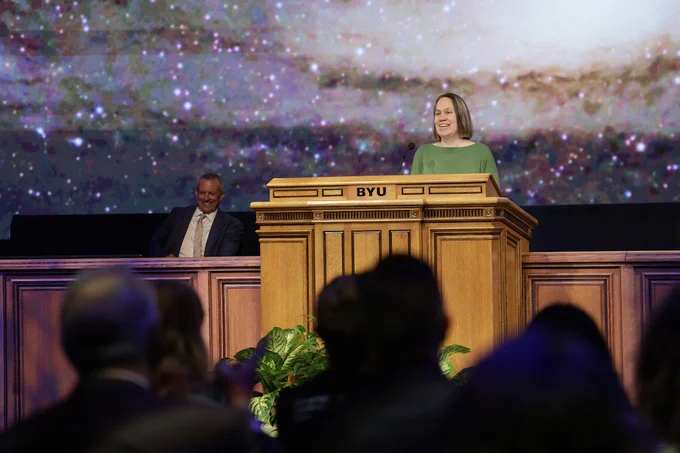 Dr. Jennifer Brooks speaks at a podium at BYU Devotional, June 2026