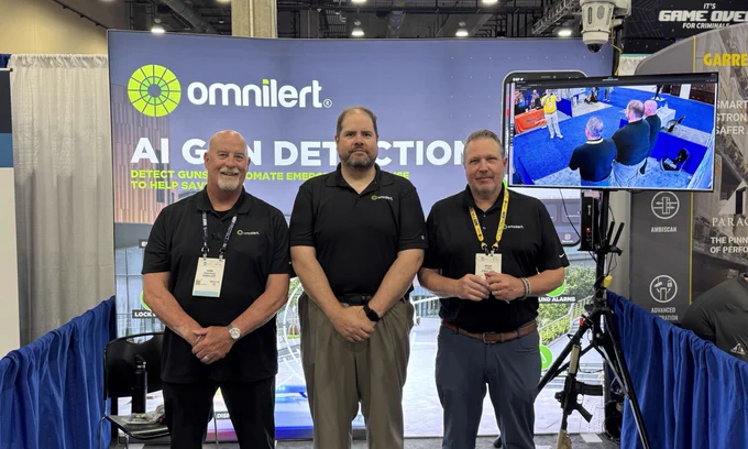 From left to right: Kirk, Rob, and Brad stand in front of the Omnilert booth at NRF PROTECT. 