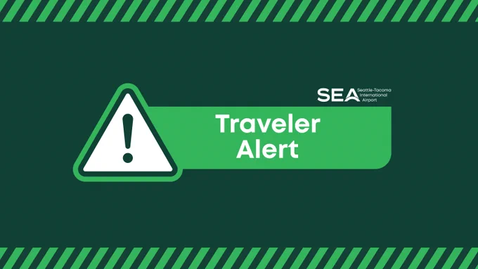 Traveler alert graphic with a warning symbol and text indicating Seattle-Tacoma International Airport.