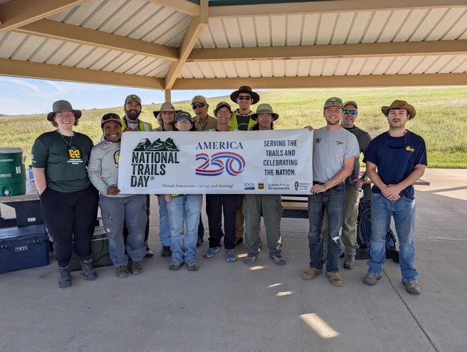 Partner organizations gathered at the Buffalo Gap Campground Group Picnic Area for National Trails Day, June 6, 2026, to prepare for work on the Buffalo Gap Trail bridge replacement project. Volunteers from the Maah Daah Hey Trail Association, Badlands Conservation Alliance, Badlands Conservation Corps and Montana Conservation Corps joined DPG staff for the hands‑on event. Forest Service photo by Scott C. Marvin.
