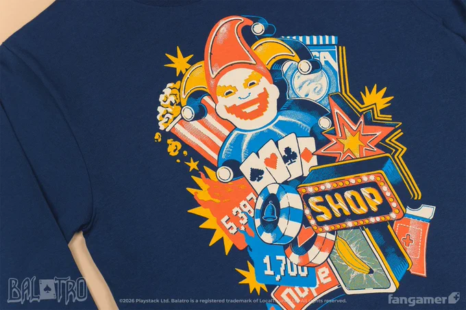 A photo of Ante Up, a navy long-sleeved shirt featuring elements from Balatro—a Joker, scores, chips, the SHOP sign, Gros Michel—arranged around four cards with the suit symbols on them. 