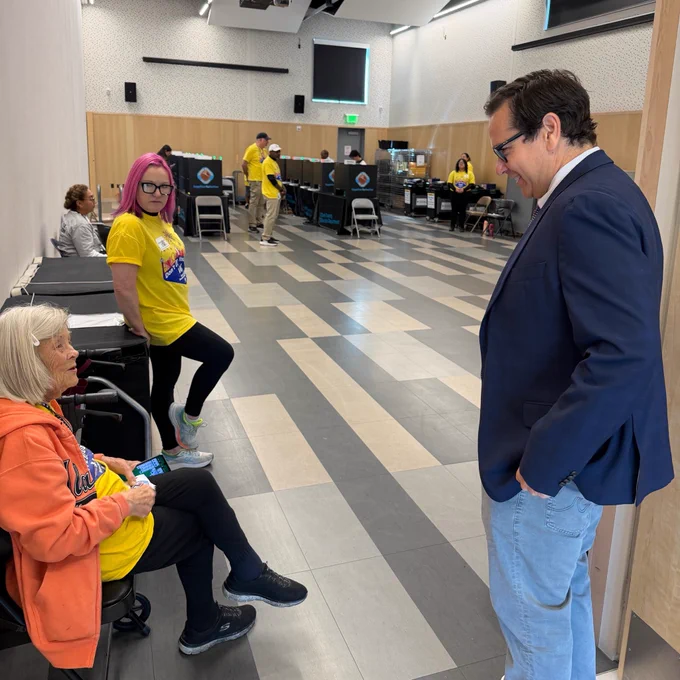Secretary Aguilar talks with poll workers at East Las Vegas Library