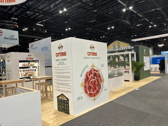 A trade show booth featuring Citterio branding and displays. The setup highlights superior Italian quality products with modern, sleek design. The atmosphere is professional and inviting.