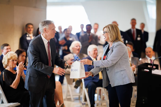 Dr. LouAnn Woodward presents Hall with a watch – “or two” – in recognition of his many years of dedicated service to UMMC.
