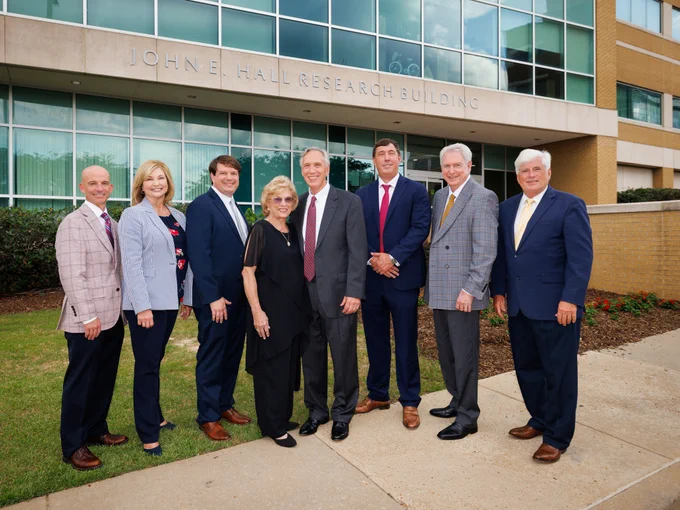 Colleagues celebrate a milestone that ensures Hall's legacy will inspire future generations of students, researchers and physicians. They are Dr. Alan Jones, left, Woodward, Bidwell, Becky and Dr. John Hall, Dr. Michael Hall, Dr. Dan Jones and Granger.