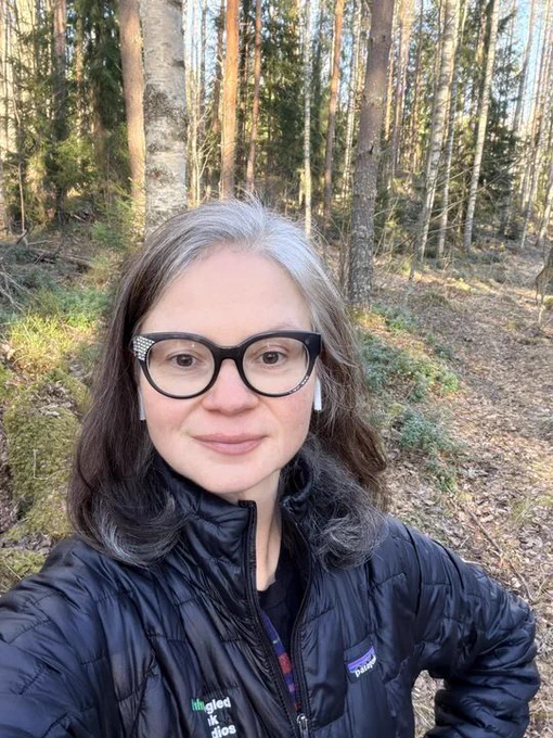 Portrait of Marjee looking for portal to the underworld in the Finnish woods.