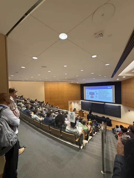 Sorab Panday presents his featured talk to a full lecture hall, with a slide behind him reading: "The future of sustainability isn't just better science, but also better accessibility and communication."